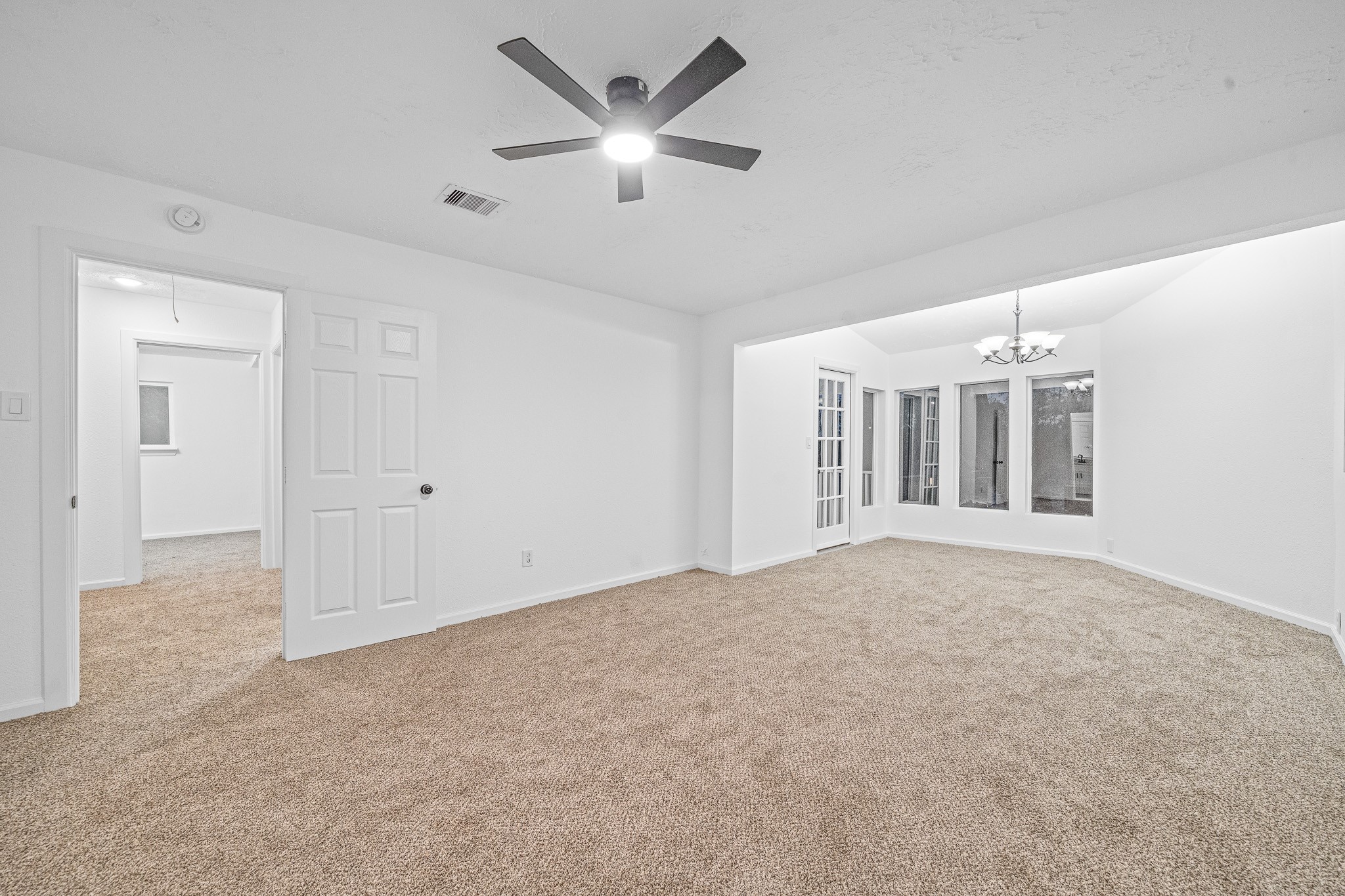 6706 Trigate Drive Houston, TX 77489 - Photo 34 of 40 an empty room with chandelier fan and windows