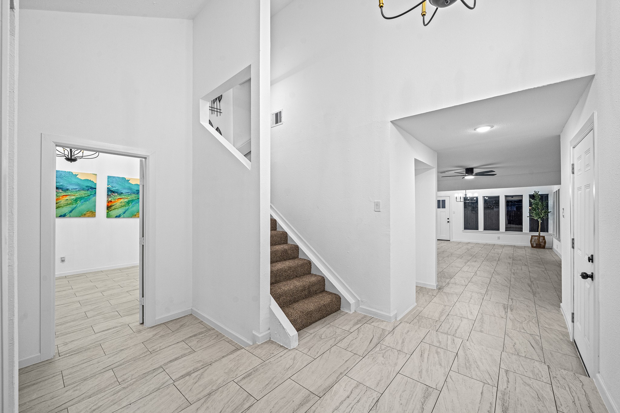 6706 Trigate Drive Houston, TX 77489 - Photo 4 of 40 a view of a hallway with wooden floor and staircase