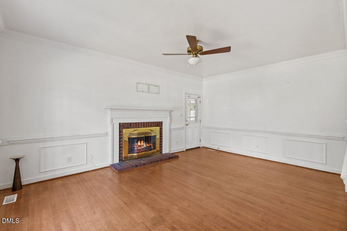 3812 Providence Road Rocky Mount, NC 27803 - Photo 3 of 18 a view of an empty room with a fireplace and a window