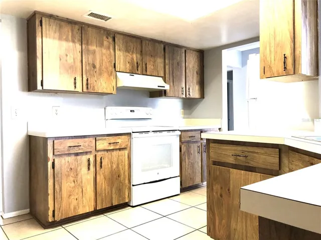 a kitchen with stainless steel appliances granite countertop a sink and a stove