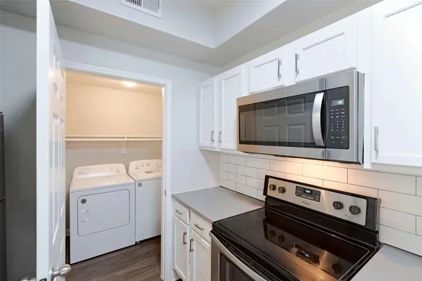 a kitchen with a stove and a microwave