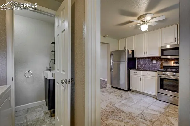 a kitchen with a refrigerator a sink and cabinets