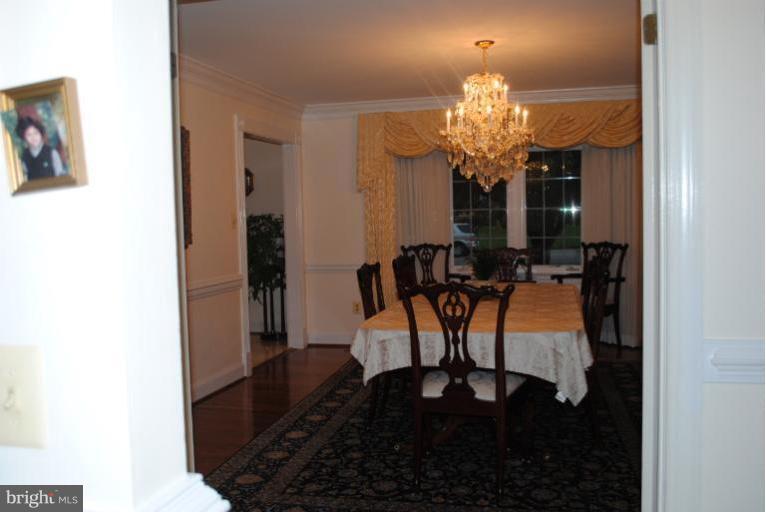 9711 Middleton Ridge Road Vienna, VA 22182 - Photo 8 of 28 a dining room with furniture and chandelier kitchen view