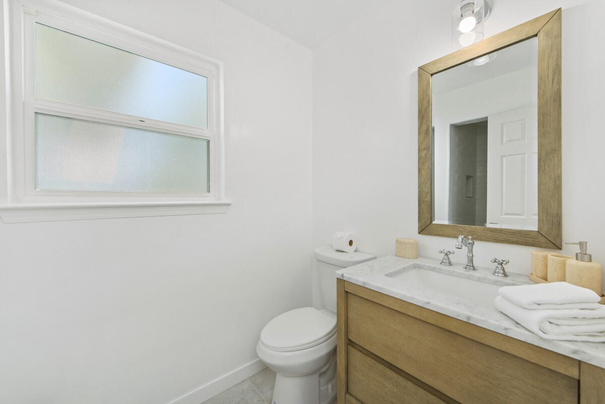 681 Daniel Drive Santa Maria, CA 93454 - Photo 19 of 26 a bathroom with a granite countertop toilet sink and mirror