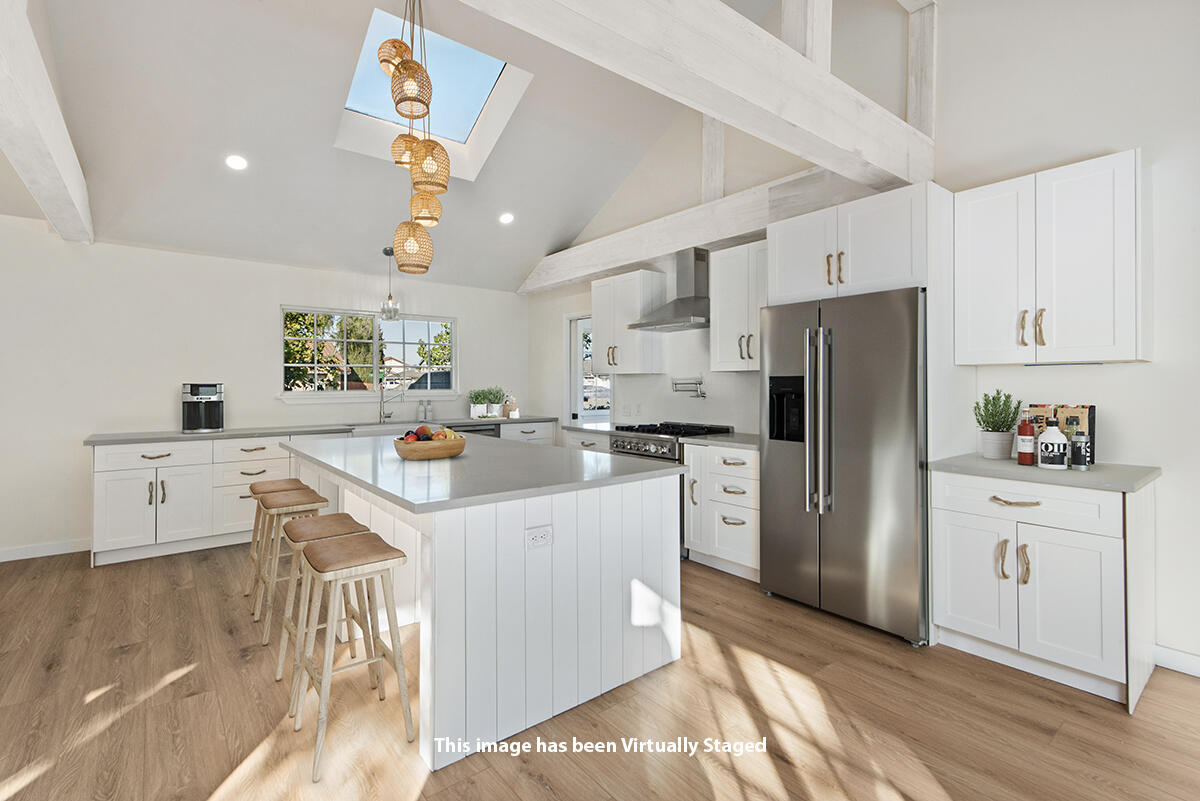 681 Daniel Drive Santa Maria, CA 93454 - Photo 6 of 26 a kitchen with refrigerator a stove a sink dishwasher and white cabinets with wooden floor