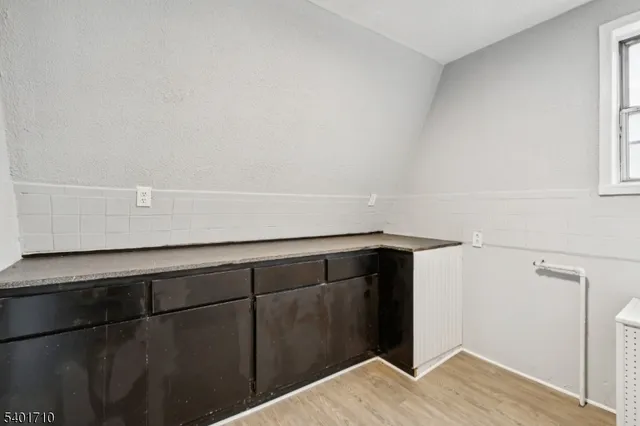a view of storage and utility room with closet