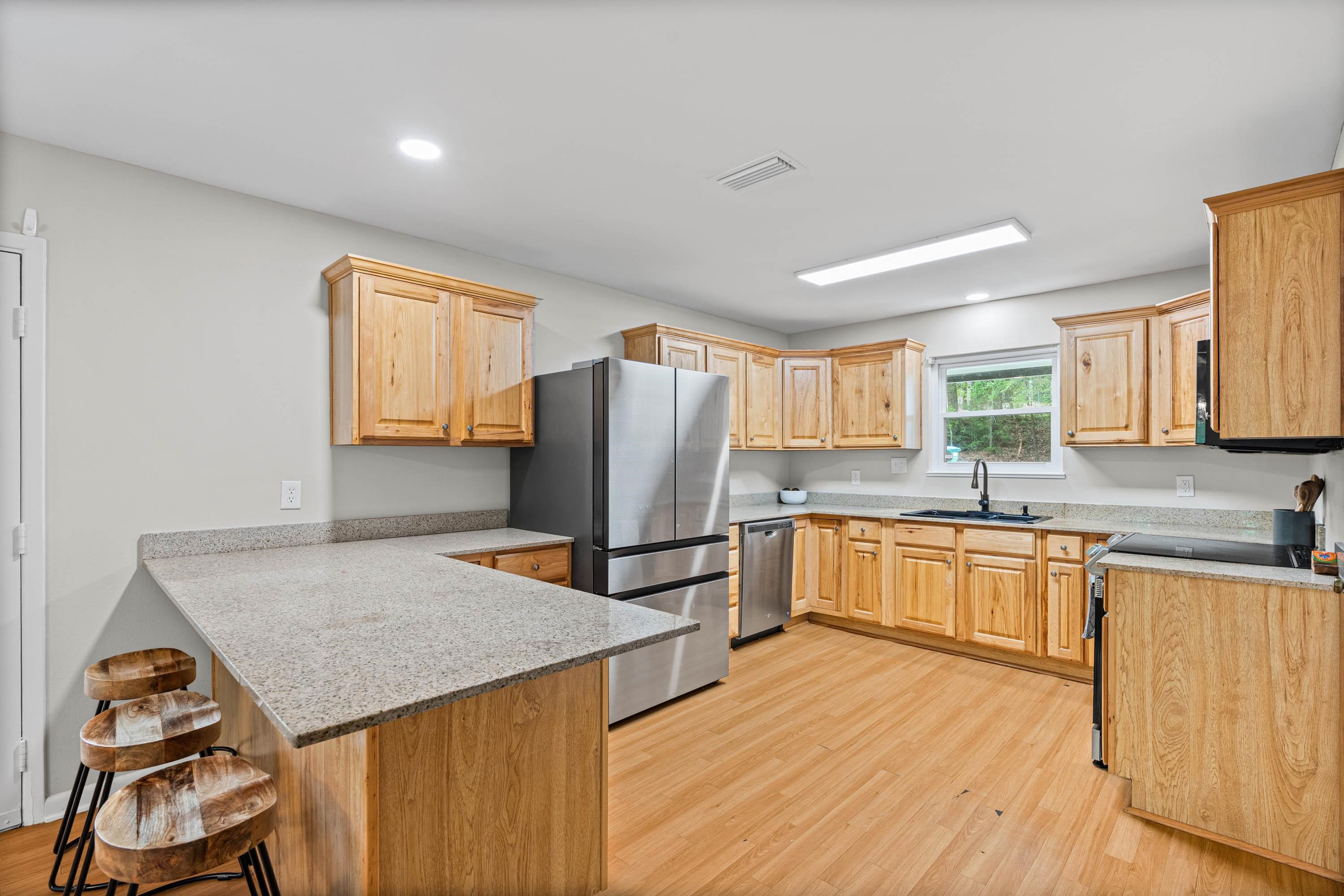 58 Caisson Trace Daphne, AL 36527 - Photo 6 of 27 Kitchen with Granite Countertops and Breakfast Bar