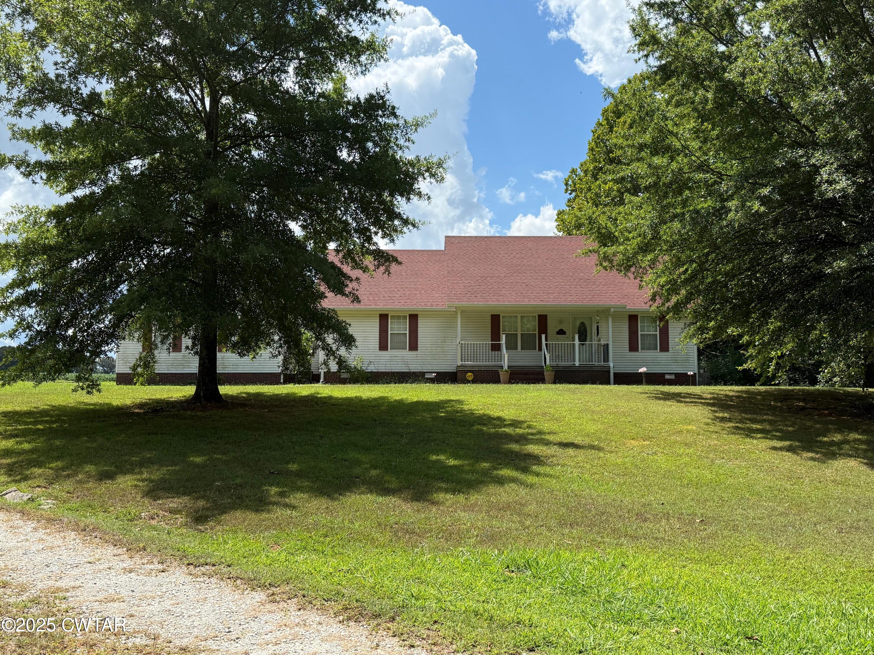 a front view of a house with a big yard
