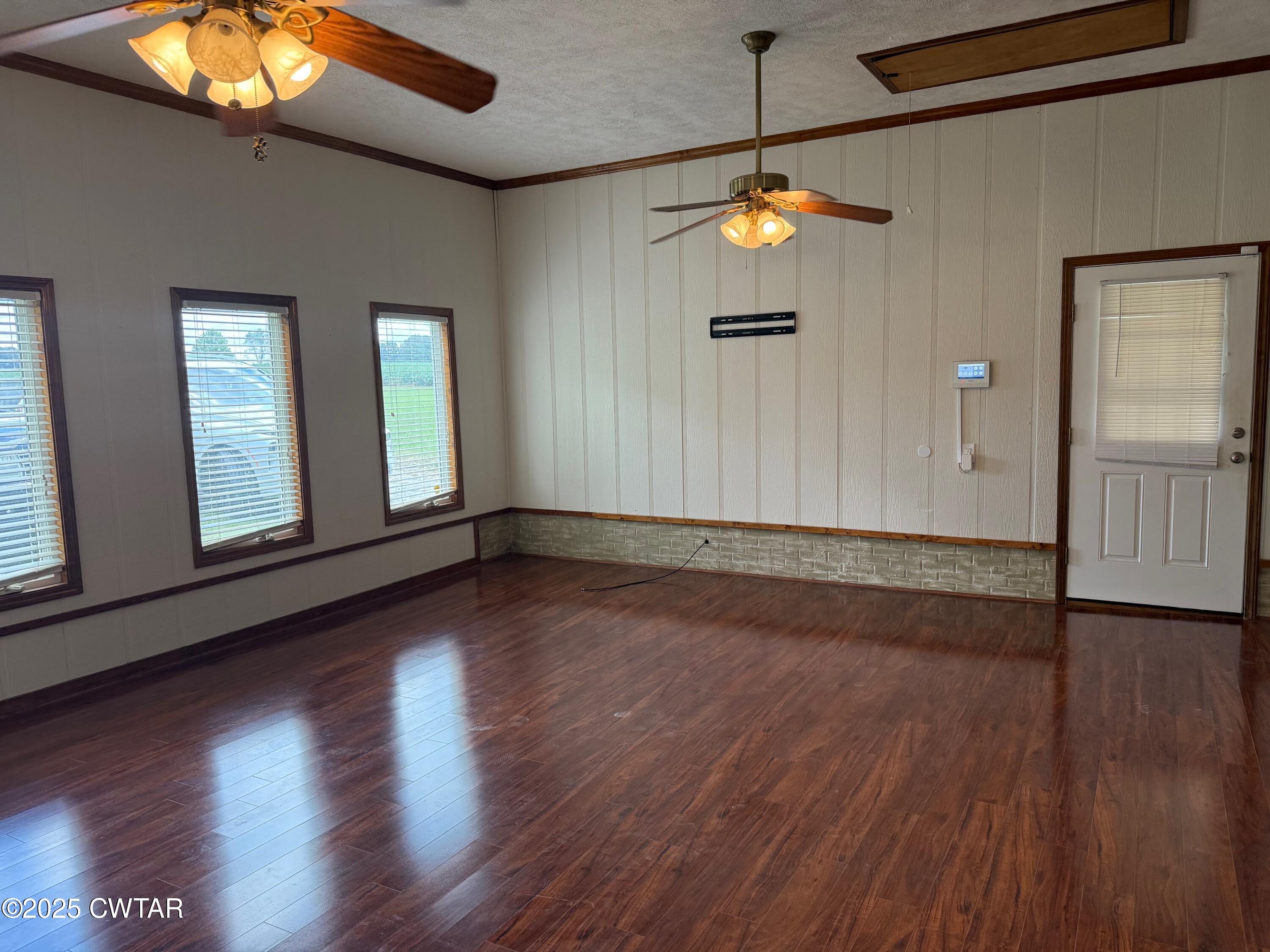 860 Plainview Road Henderson, TN 38340 - Photo 5 of 10 a view of empty room with wooden floor and fan