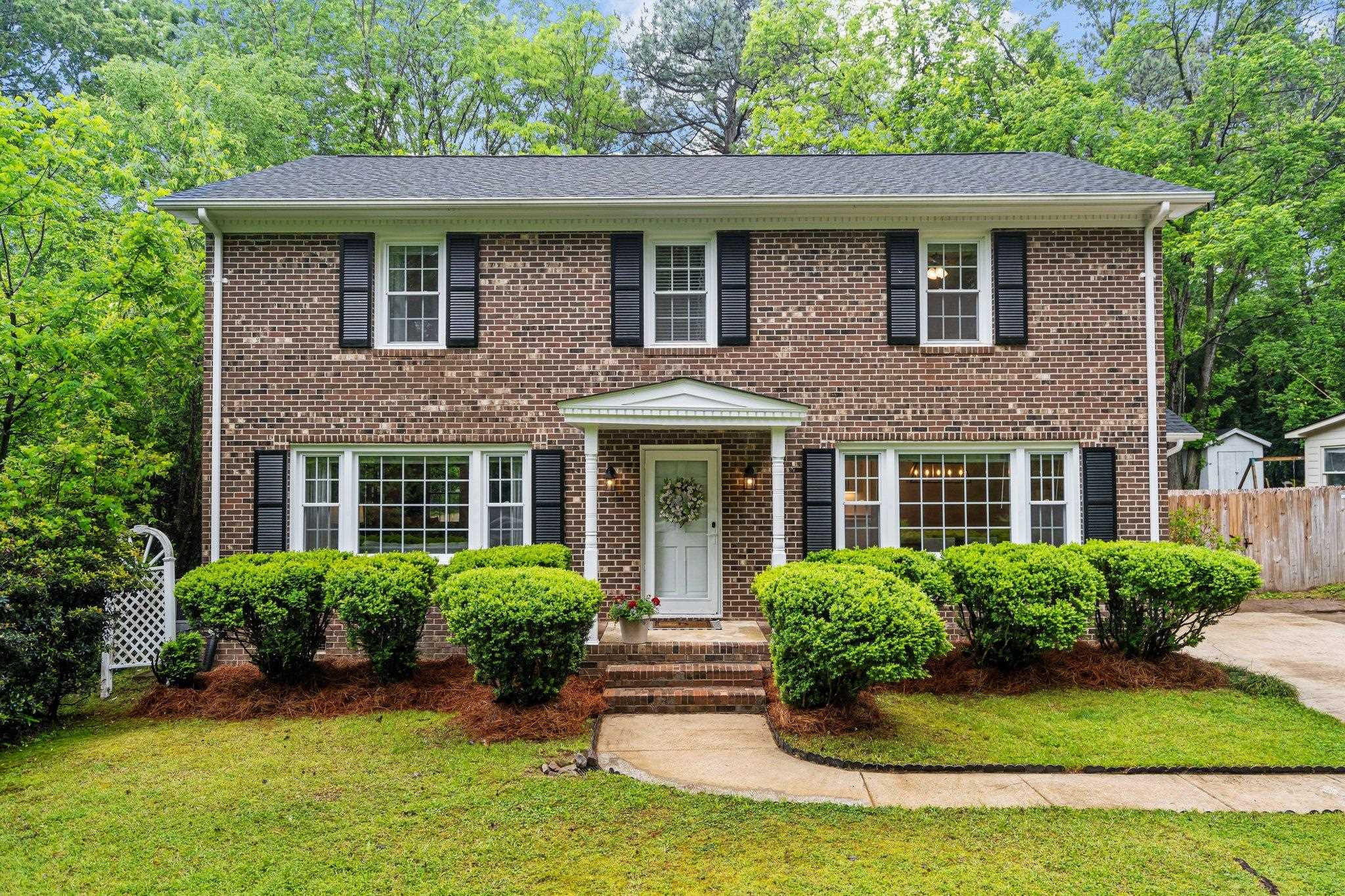 5209 Cedarwood Drive Raleigh, NC 27609 - Photo 1 of 33 a front view of a house with yard and green space