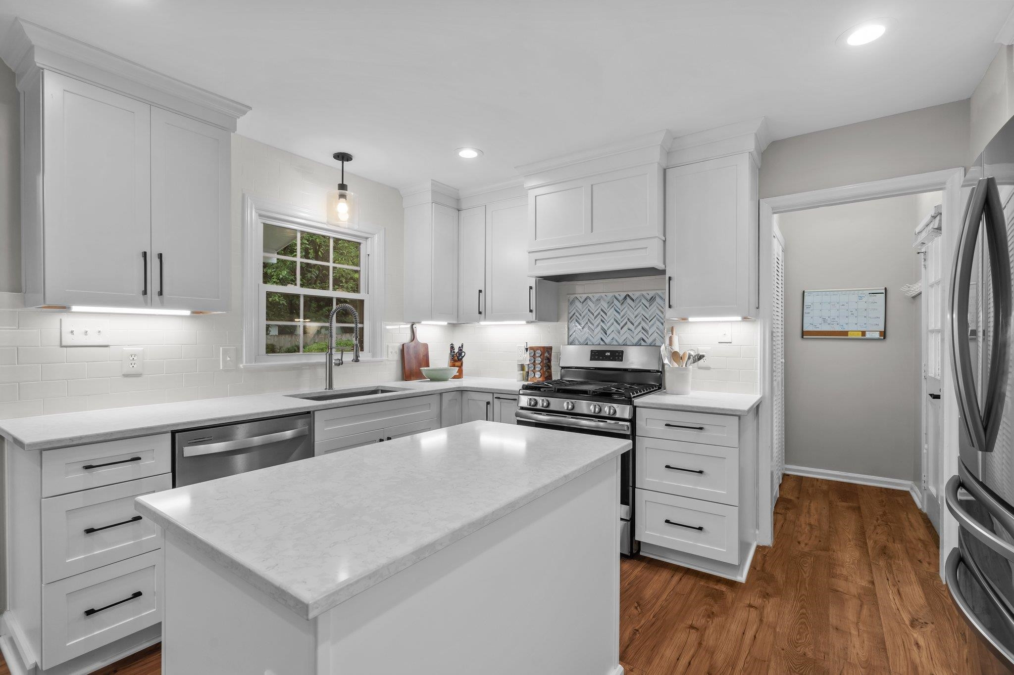 5209 Cedarwood Drive Raleigh, NC 27609 - Photo 7 of 33 a kitchen with wooden cabinets and white appliances