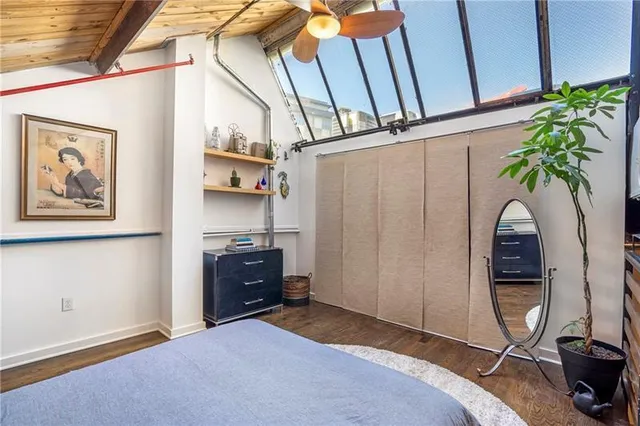 a bedroom with a bed and a potted plant