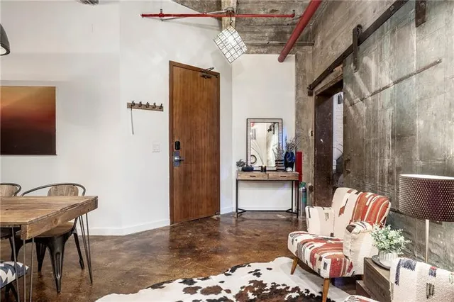 a living room with furniture and a mirror