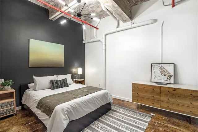 a bedroom with a bed and a mirror