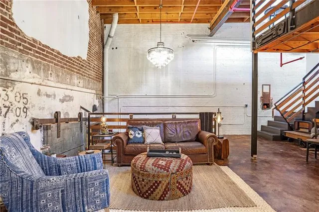 a living room with furniture and a chandelier