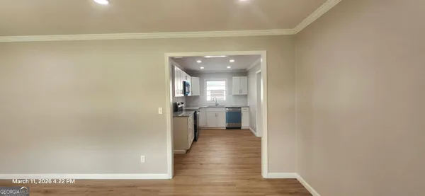 a living room with a stove and a microwave