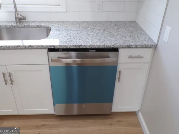 a white toilet sitting next to a bathroom sink