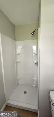 a view of an empty room with wooden floor