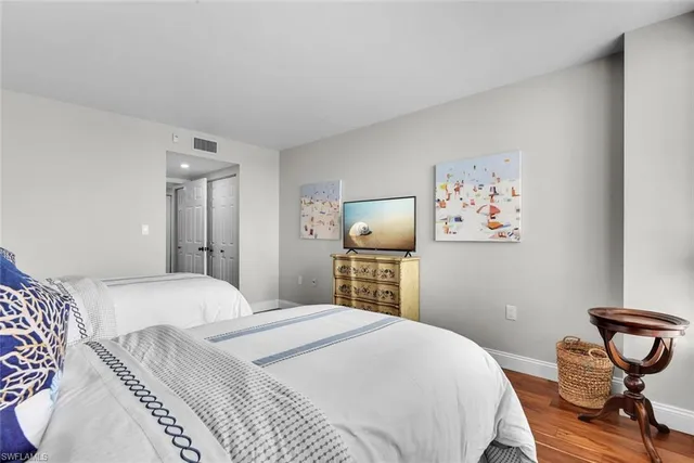 a bedroom with a bed and a tv on table