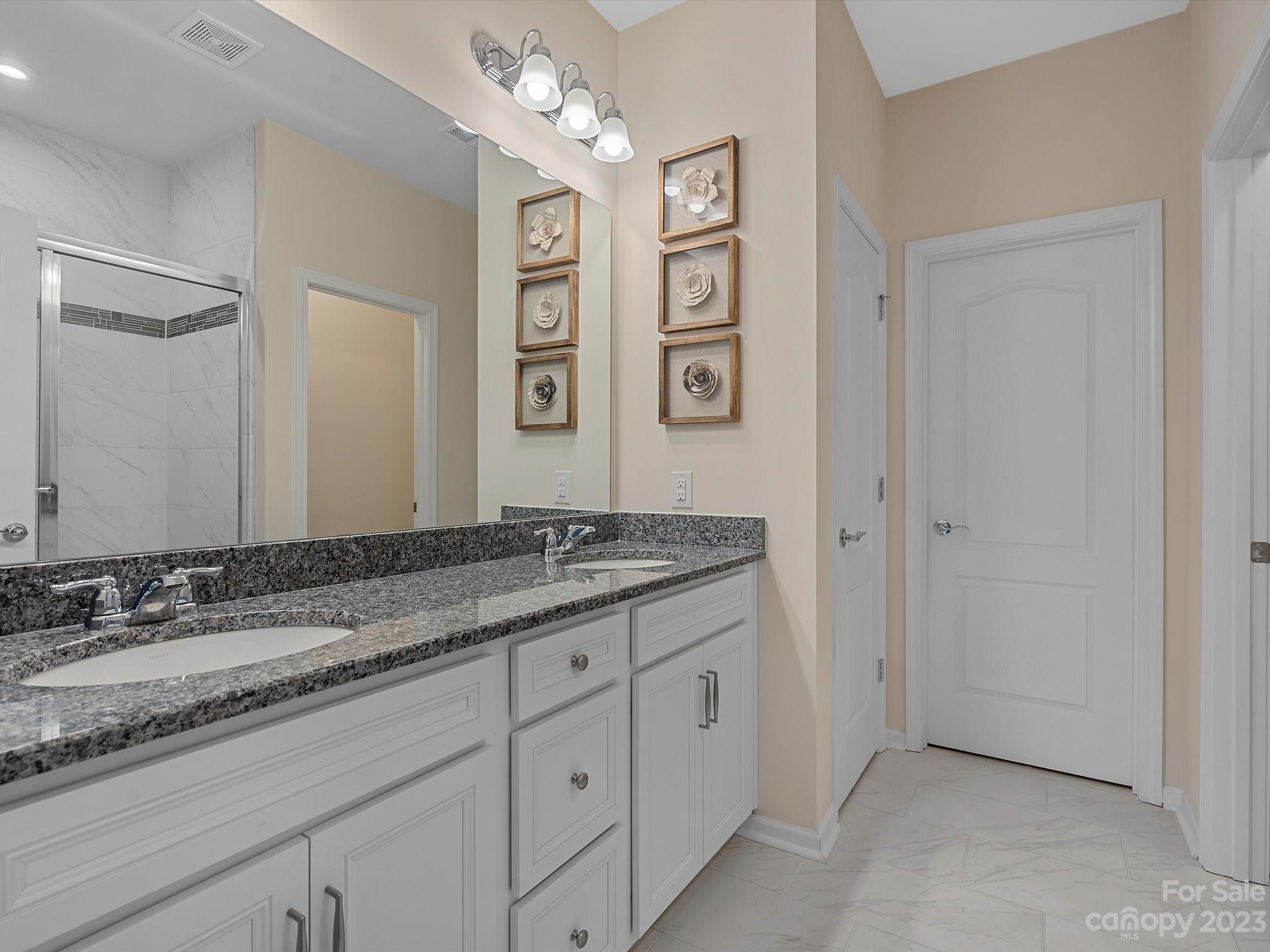 3071 Hartson Pointe Drive Indian Land, SC 29707 - Photo 16 of 48 a bathroom with a granite countertop sink mirror and double
