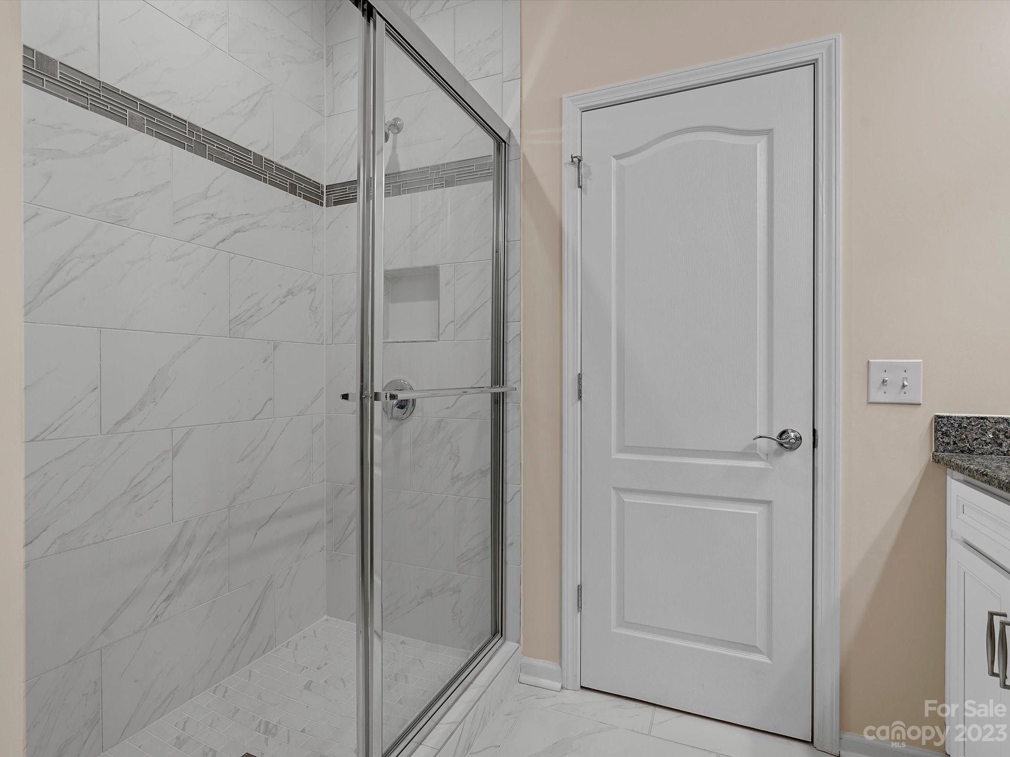 3071 Hartson Pointe Drive Indian Land, SC 29707 - Photo 17 of 48 a bathroom with a glass shower door