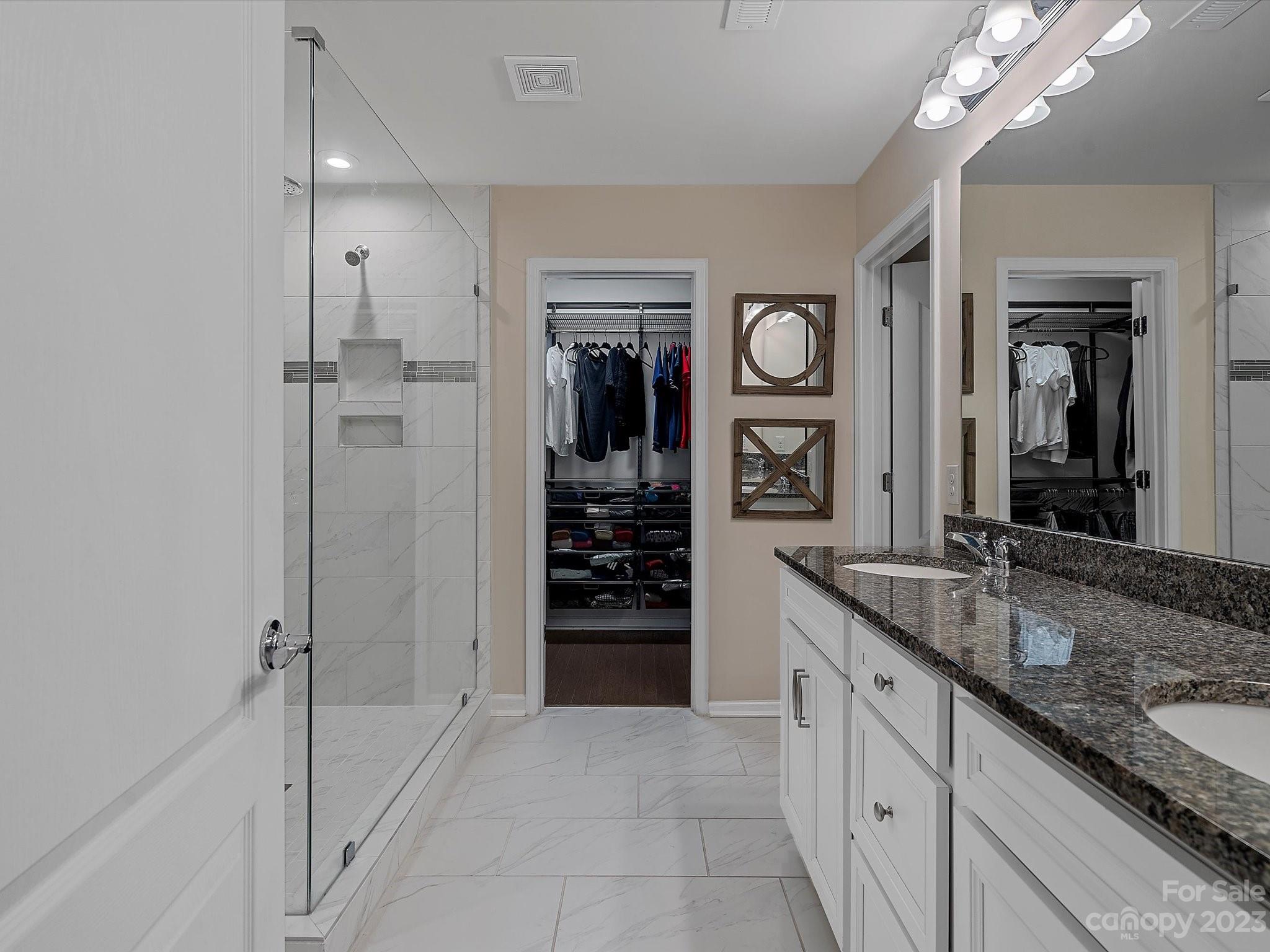 3071 Hartson Pointe Drive Indian Land, SC 29707 - Photo 25 of 48 a spacious bathroom with a granite countertop sink and a mirror