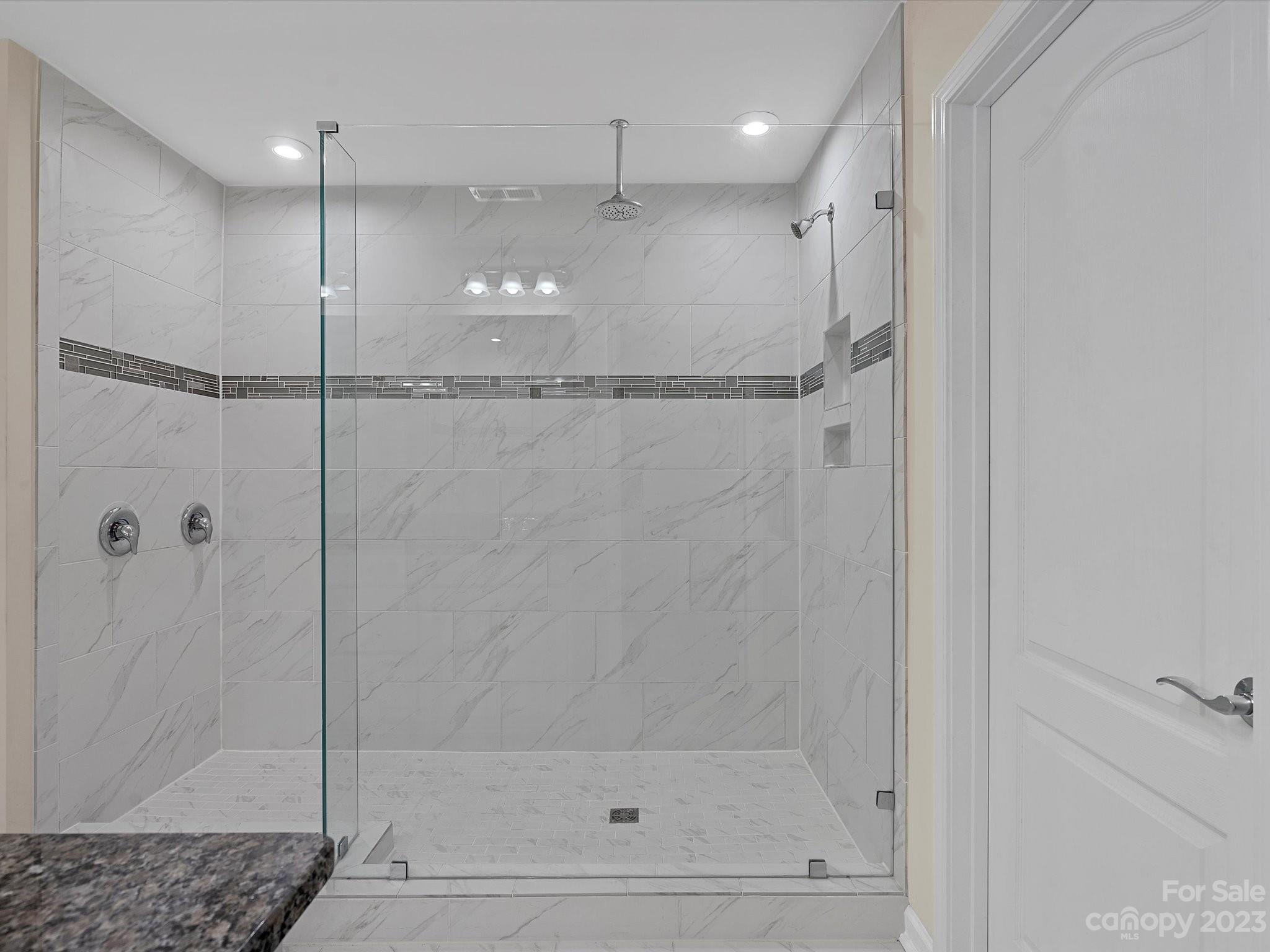 3071 Hartson Pointe Drive Indian Land, SC 29707 - Photo 27 of 48 a bathroom with a glass shower door
