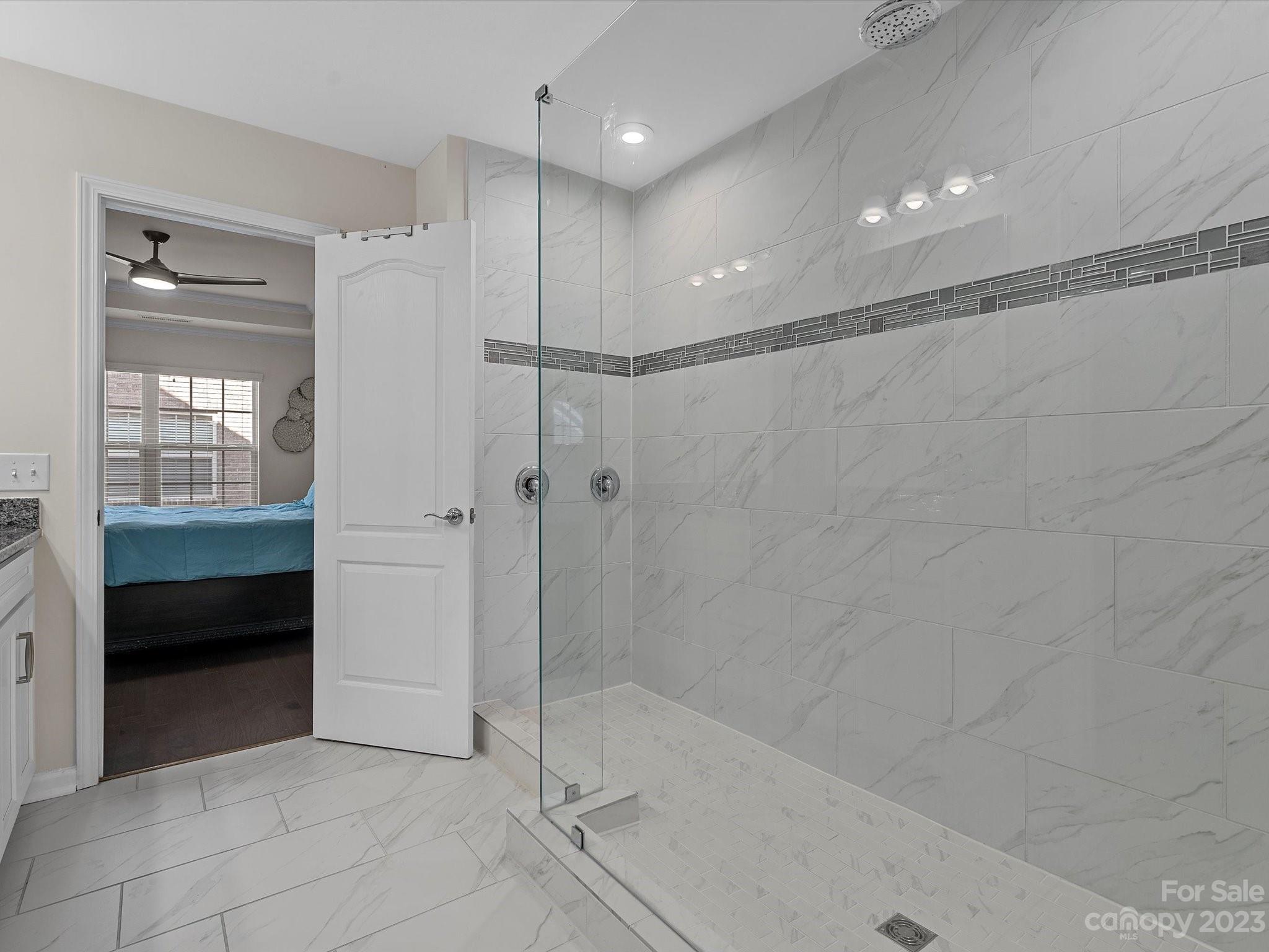 3071 Hartson Pointe Drive Indian Land, SC 29707 - Photo 29 of 48 a bathroom with a glass shower door