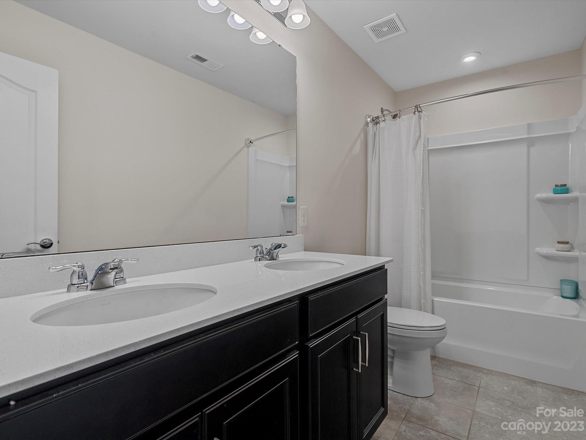 3071 Hartson Pointe Drive Indian Land, SC 29707 - Photo 35 of 48 a bathroom with a sink a toilet and shower
