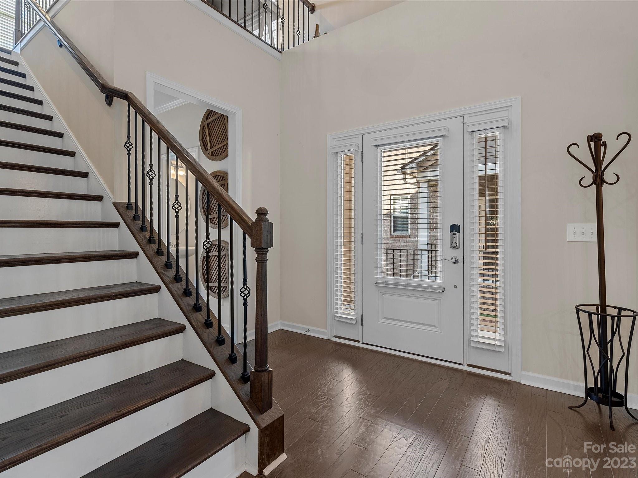 3071 Hartson Pointe Drive Indian Land, SC 29707 - Photo 4 of 48 a view of a hallway with wooden floor and stairs