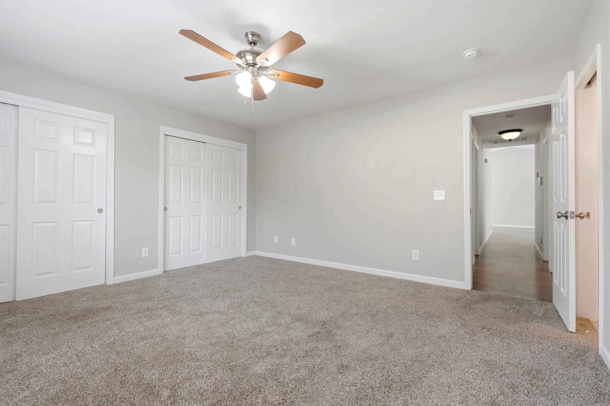 481 Katelyn Court Exeter, CA 93221 - Photo 16 of 33 an empty room with a chandelier fan and closet area