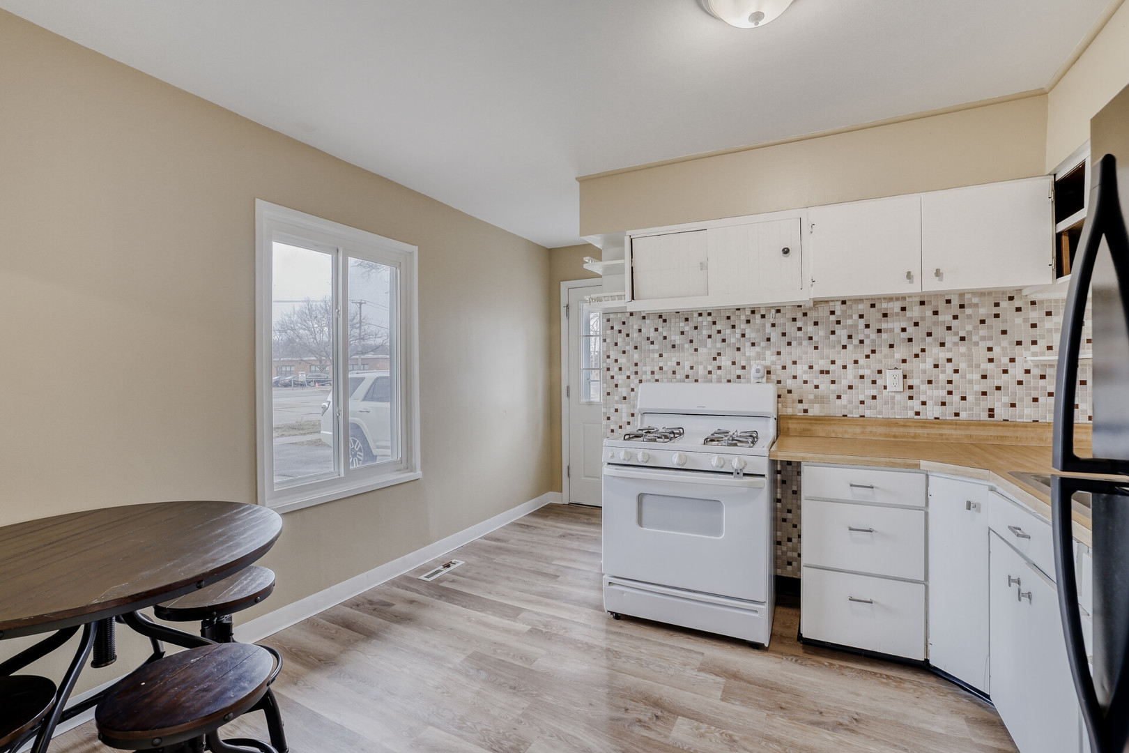 17 South Bartlett Road Streamwood, IL 60107 - Photo 5 of 16 a kitchen with white cabinets and a stove top oven