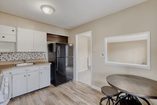 a kitchen with a refrigerator and cabinets