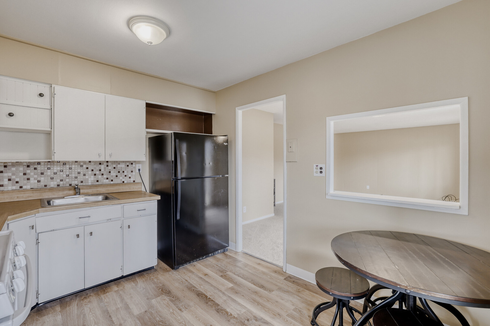 17 South Bartlett Road Streamwood, IL 60107 - Photo 6 of 16 a kitchen with a refrigerator and cabinets