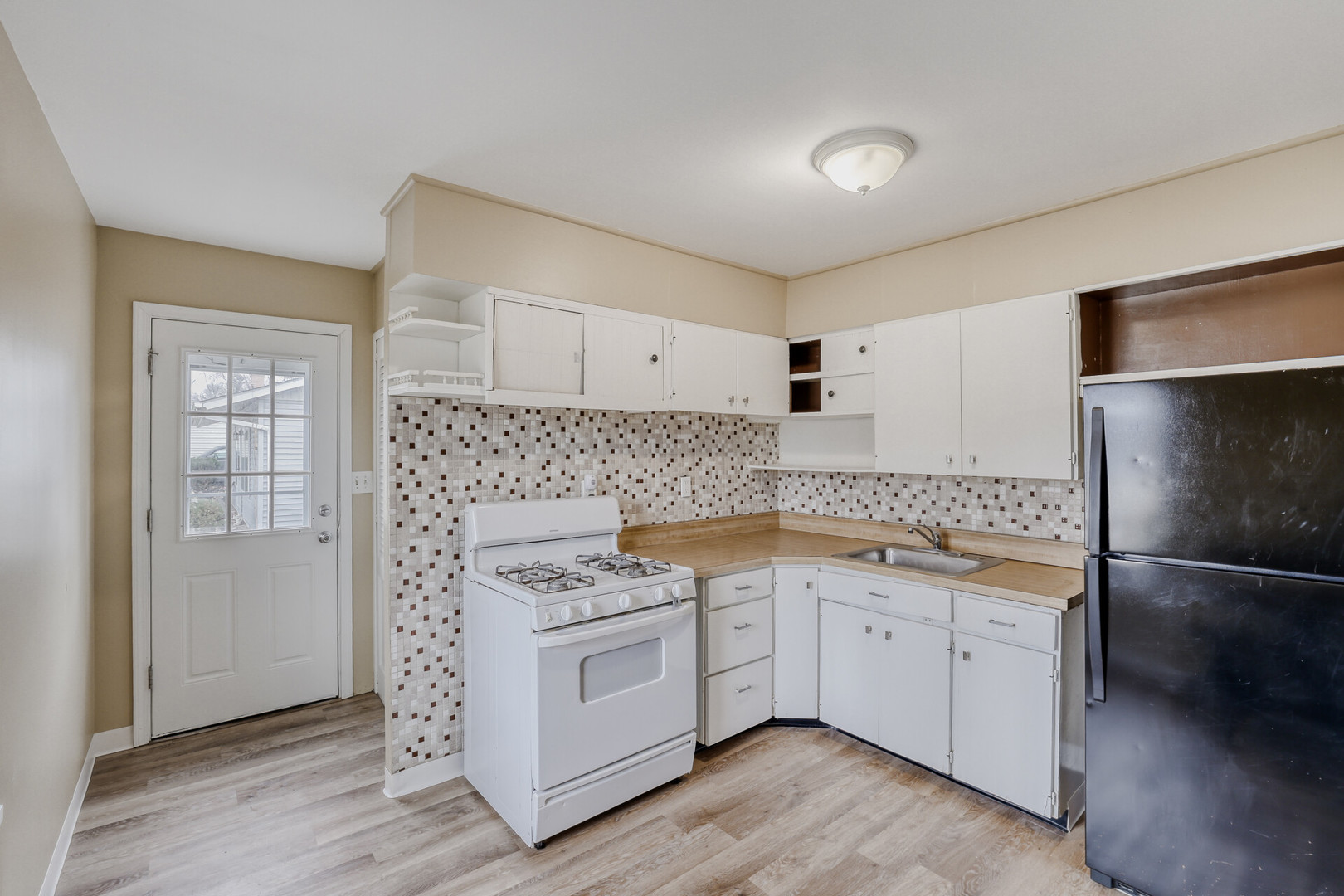 17 South Bartlett Road Streamwood, IL 60107 - Photo 7 of 16 a kitchen with a stove refrigerator sink and cabinets