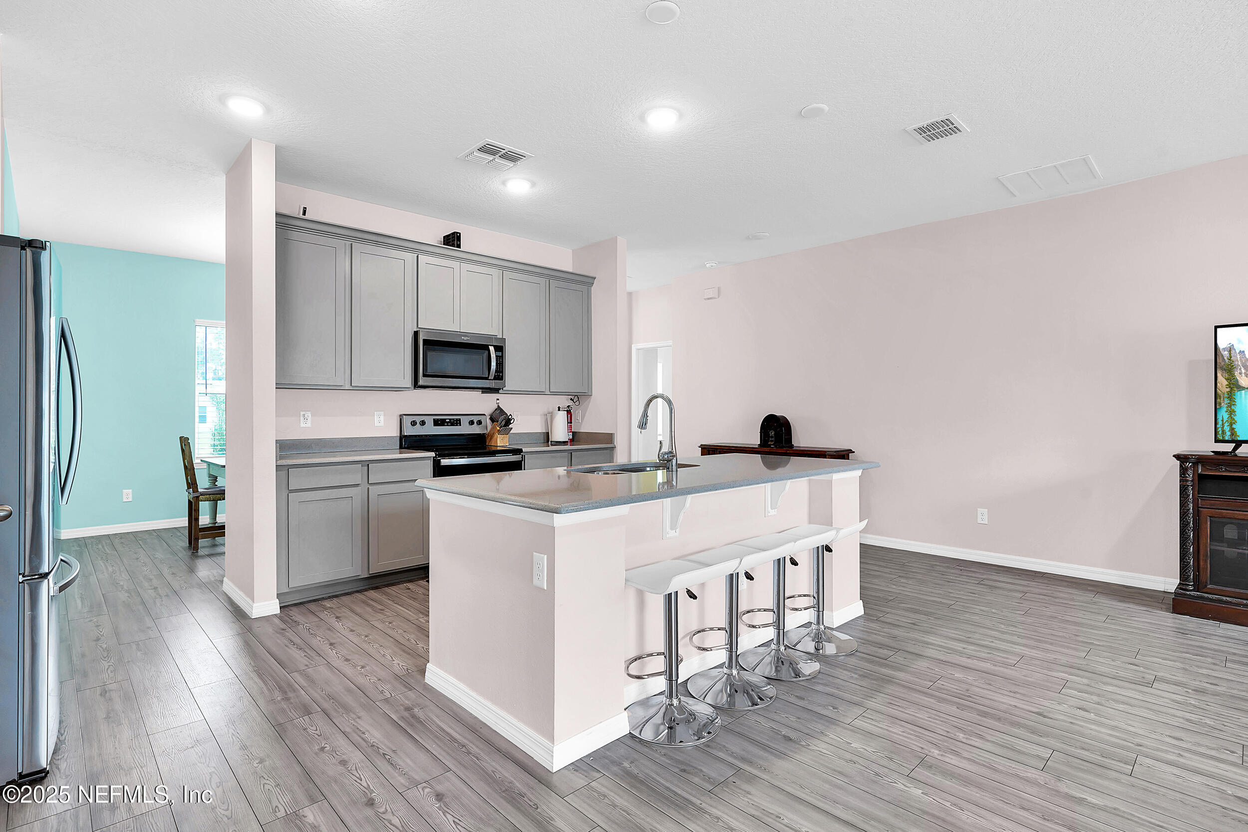 41 Seathorn Path Palm Coast, FL 32164 - Photo 13 of 48 a kitchen with a sink cabinets and wooden floor