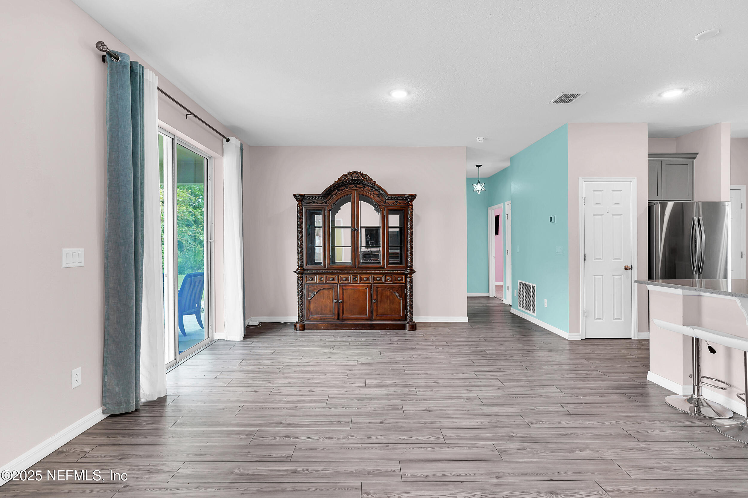 41 Seathorn Path Palm Coast, FL 32164 - Photo 15 of 48 a view of an empty room with a window and wooden floor