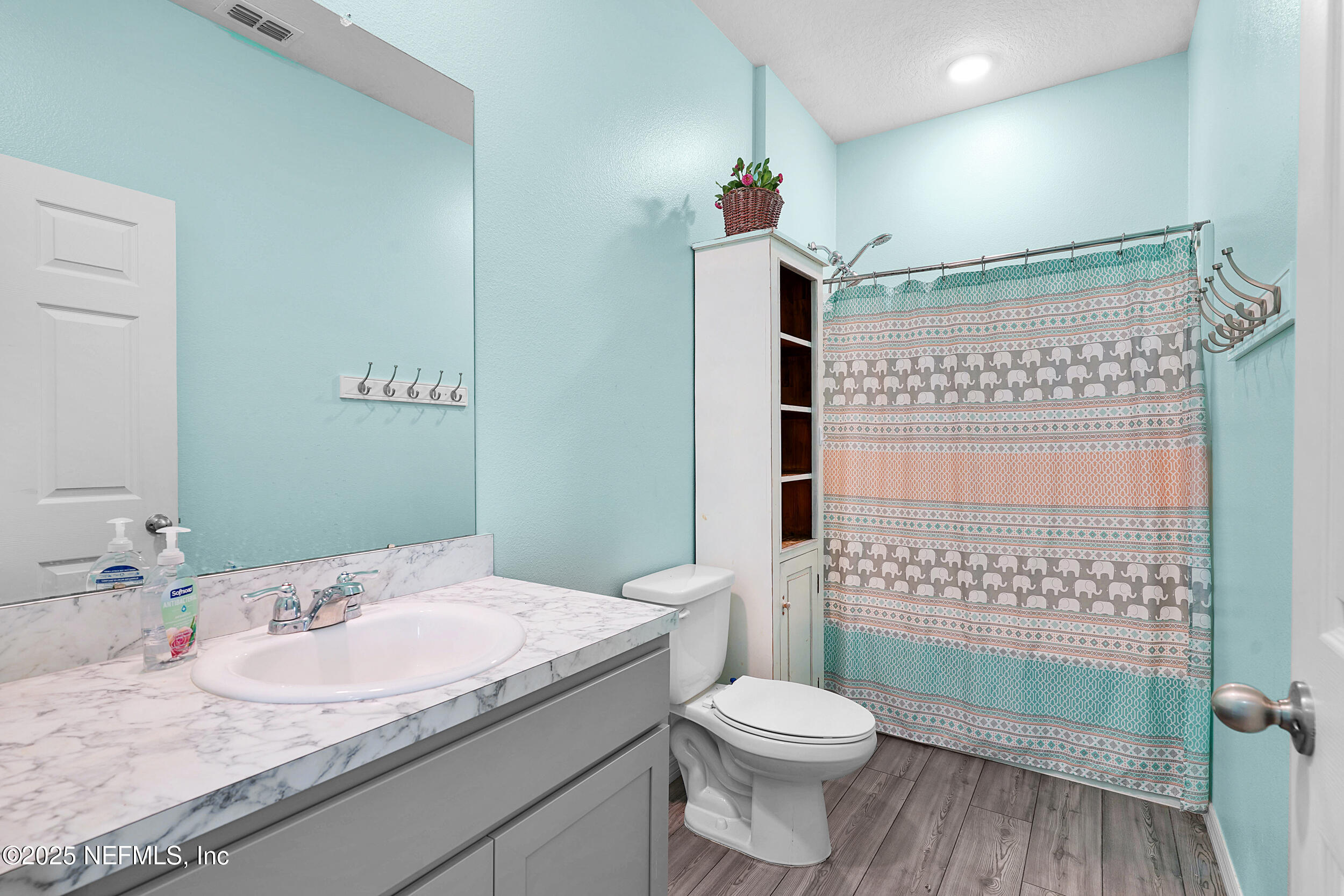 41 Seathorn Path Palm Coast, FL 32164 - Photo 19 of 48 a bathroom with a granite countertop toilet a sink and a shower