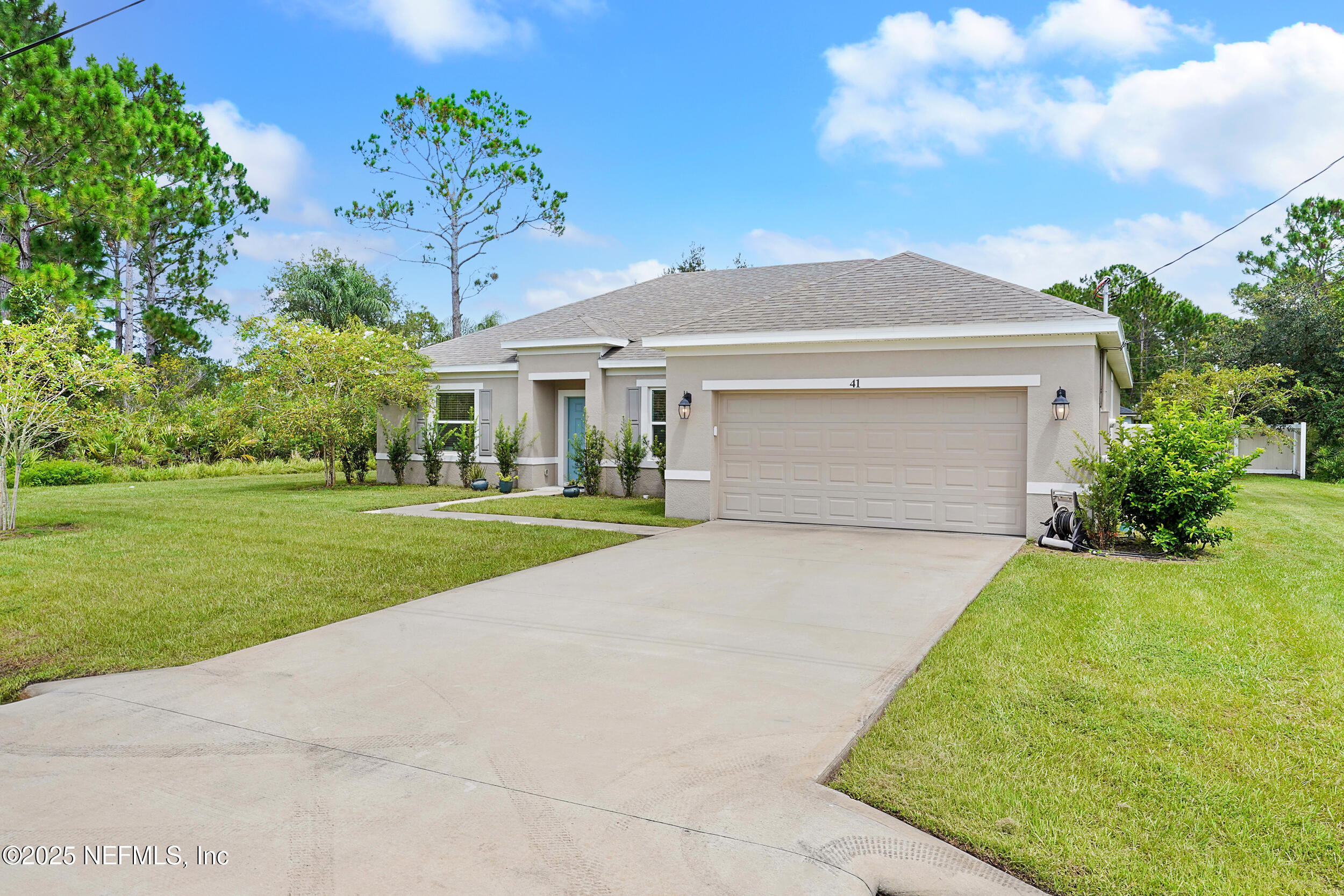 41 Seathorn Path Palm Coast, FL 32164 - Photo 2 of 48 a front view of a house with a yard and garage