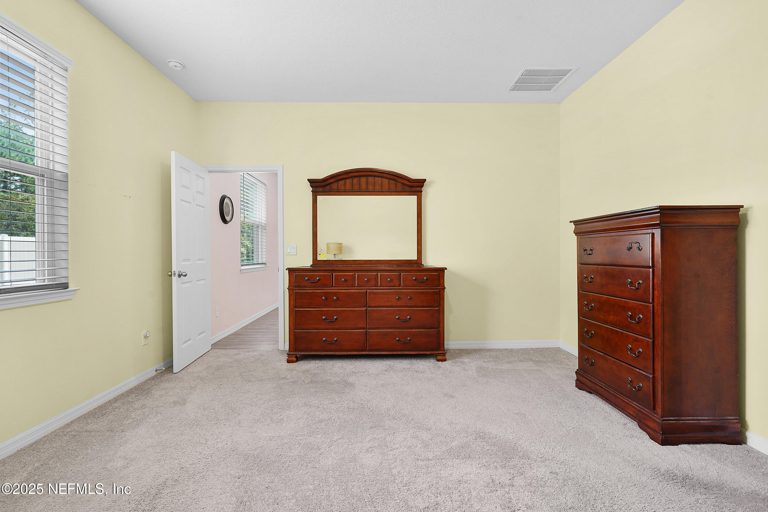 41 Seathorn Path Palm Coast, FL 32164 - Photo 25 of 48 a room with a dresser and a window