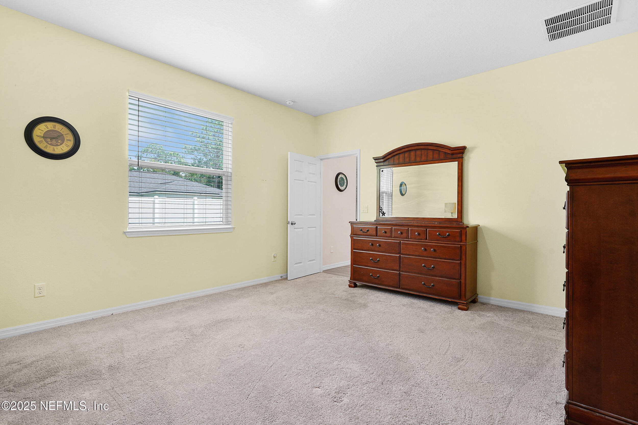 41 Seathorn Path Palm Coast, FL 32164 - Photo 26 of 48 a room with a dresser and a window