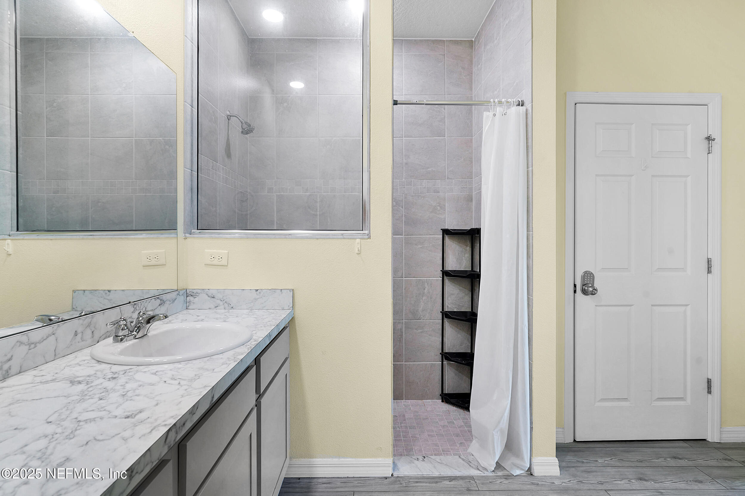 41 Seathorn Path Palm Coast, FL 32164 - Photo 28 of 48 a bathroom with a granite countertop sink and a mirror
