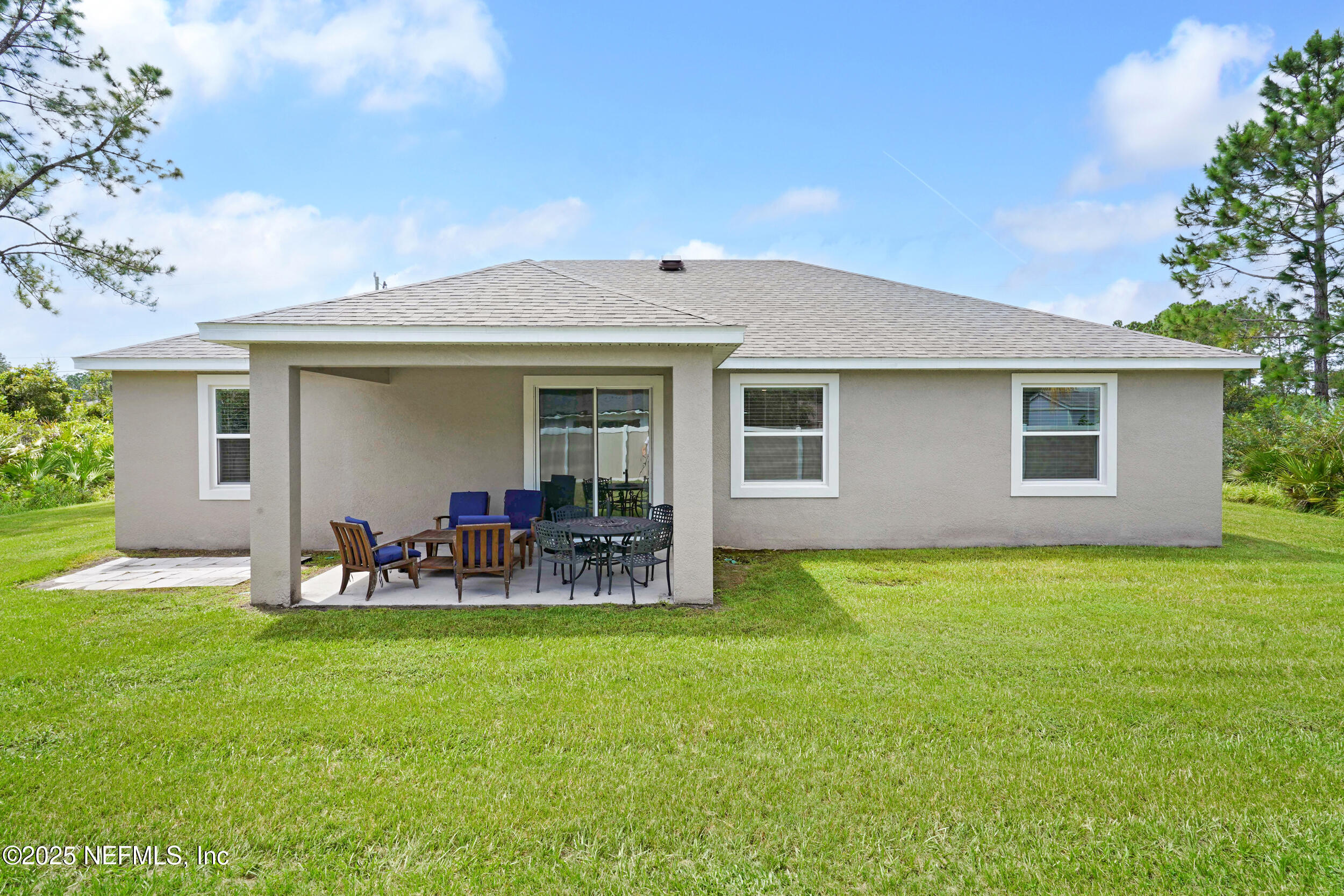 41 Seathorn Path Palm Coast, FL 32164 - Photo 35 of 48 a view of a chair and table in backyard of the house
