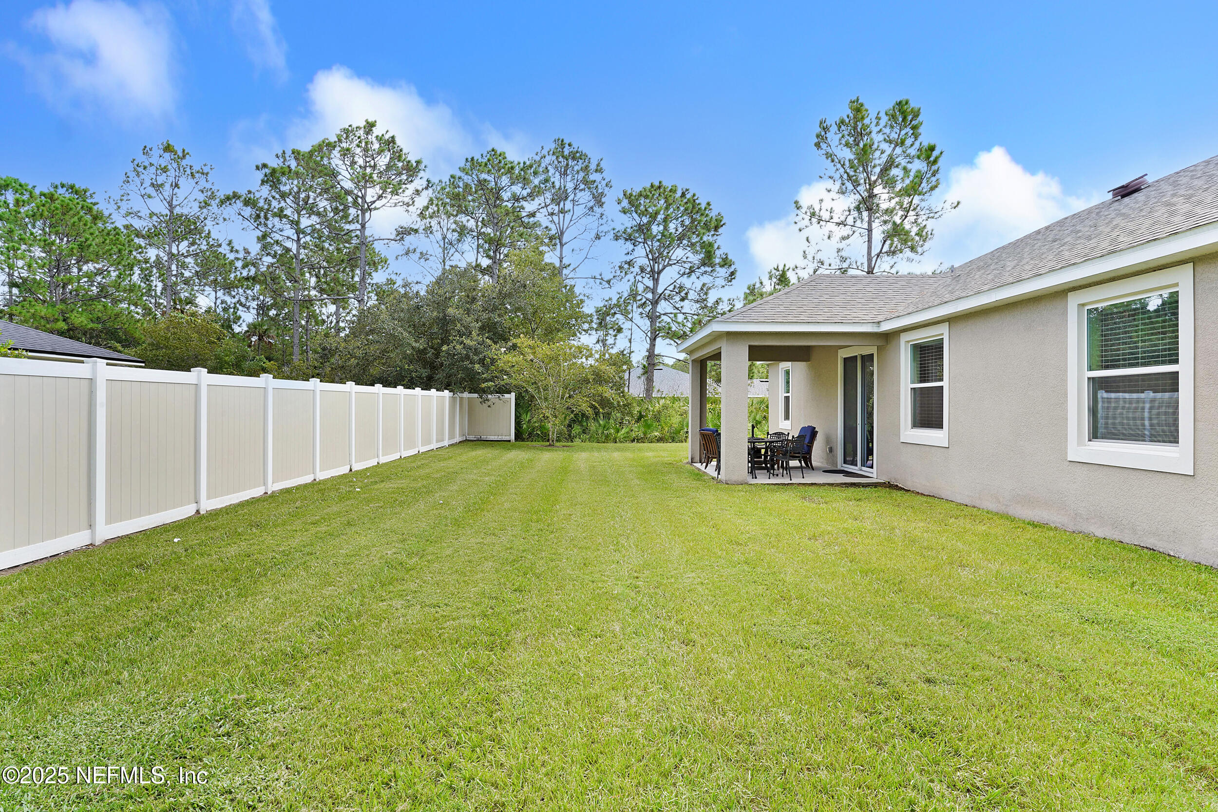 41 Seathorn Path Palm Coast, FL 32164 - Photo 37 of 48 a view of a house with backyard and a tree
