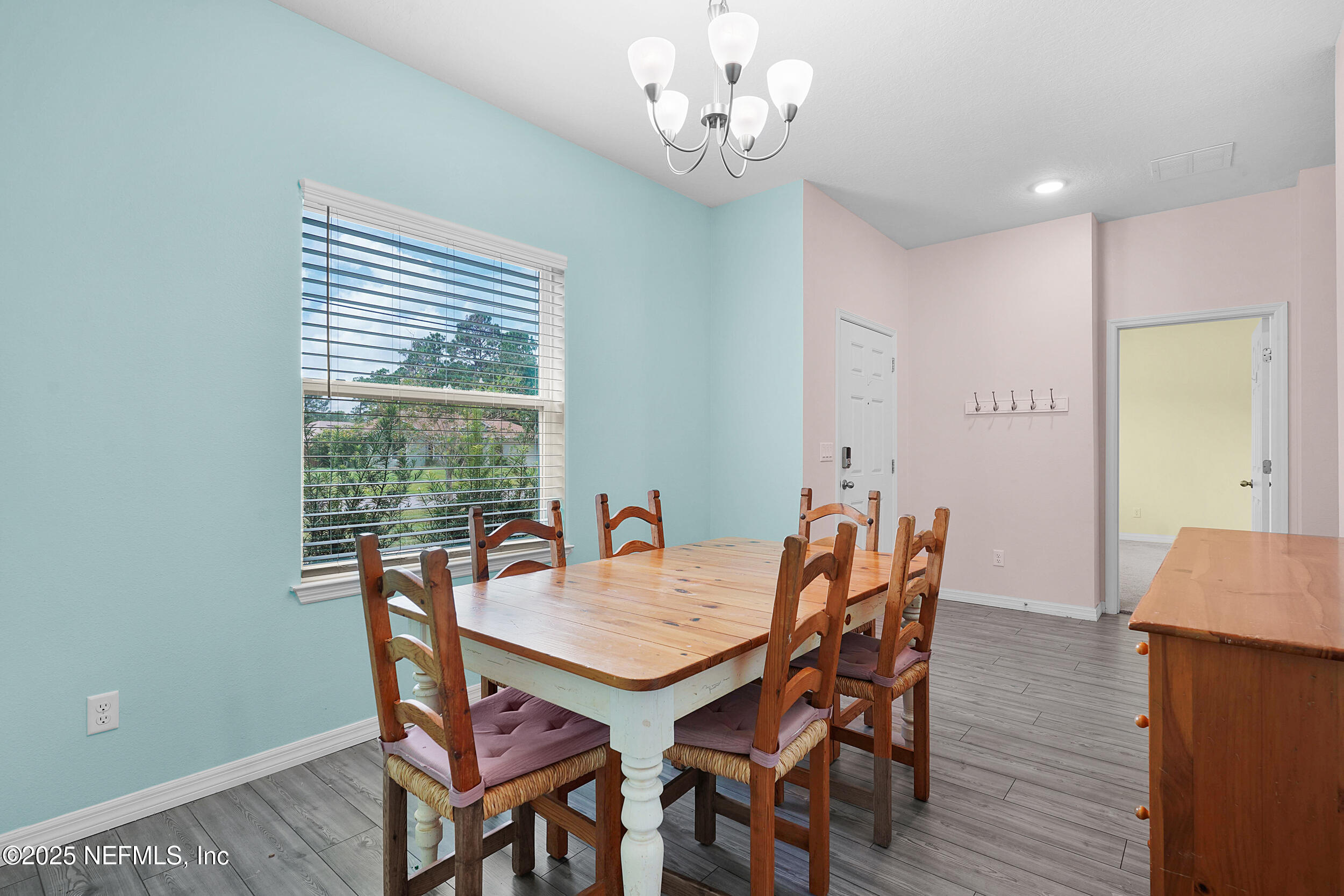 41 Seathorn Path Palm Coast, FL 32164 - Photo 6 of 48 a view of a dining room with furniture window and wooden floor