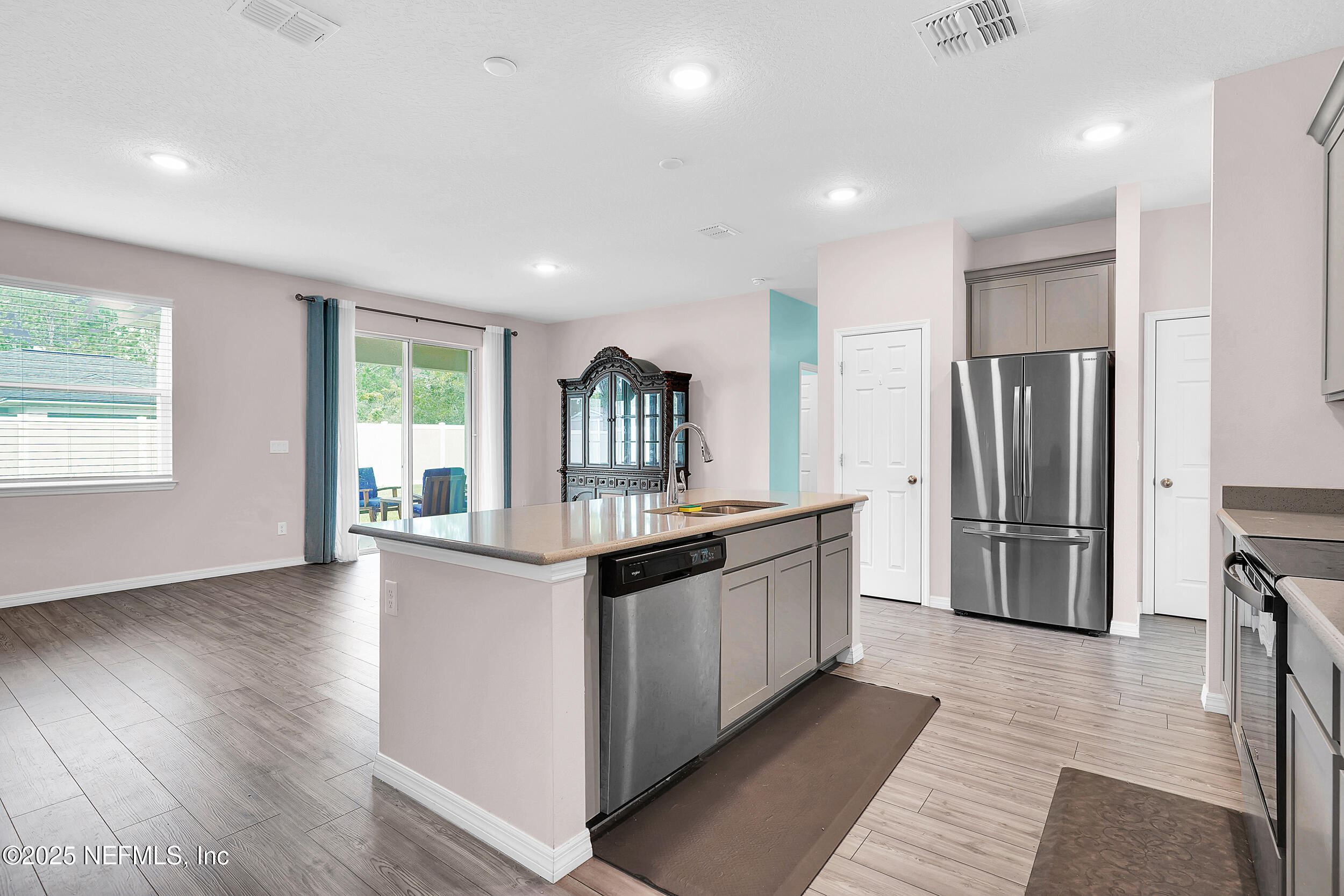 41 Seathorn Path Palm Coast, FL 32164 - Photo 9 of 48 a kitchen with stainless steel appliances granite countertop a refrigerator a stove a sink and a large window