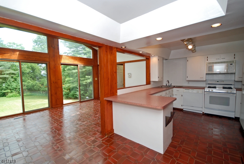 1 Old Mill Road Fairfield, NJ 07004 - Photo 2 of 14 a kitchen with stainless steel appliances granite countertop a stove a sink and a refrigerator