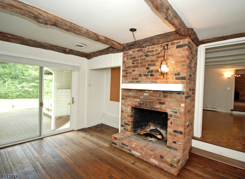 1 Old Mill Road Fairfield, NJ 07004 - Photo 8 of 14 a living room with wooden floor and a fireplace