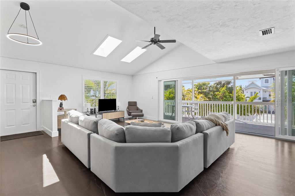 315 Spring Avenue Anna Maria, FL 34216 - Photo 9 of 63 a living room with furniture and a large window