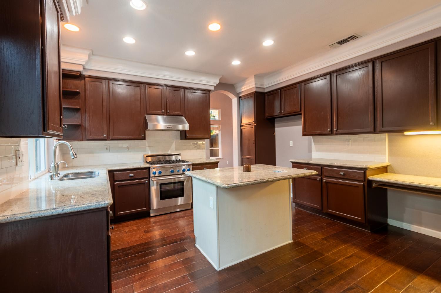 2024 Archer Circle Rocklin, CA 95765 - Photo 12 of 52 a kitchen with stainless steel appliances granite countertop wooden cabinets a stove top oven a sink and dishwasher